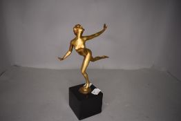 An art deco gilt bronze figurine depicting nude dancing lady on black marble base, possibly '