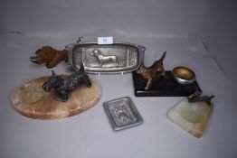 A selection of art deco ashtrays with dog figures attached
