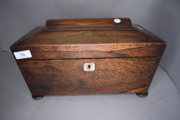 A mahogany cased tea caddy having fitted compartmental inner
