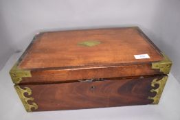 A substantial strong box style writers compendium having brass banding and mahogany case