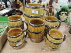 A selection of Wade mugs in the form of barrels in varied sizes.