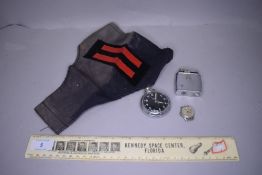 A selection of items including pocket watch a space centre ruler and arm band