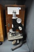 A scientific microscope in fitted case by Kima