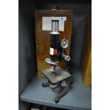 A scientific microscope in fitted case by Kima