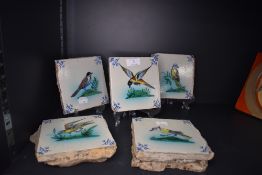 A set of five19th century hand decorated tiles, decorated in the Dutch Delft manner