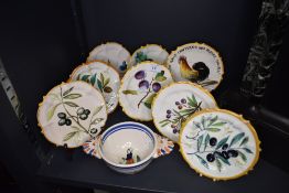 A selection of hand decorated continental plates and Quimper porringer