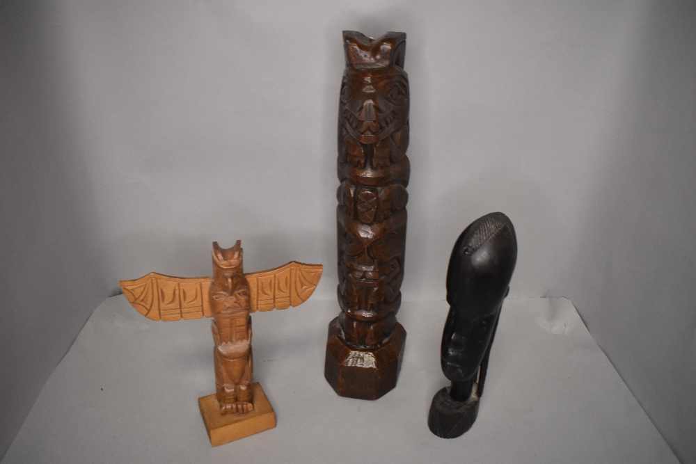 A selection of ethnic hand carved totem poles or figures