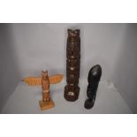 A selection of ethnic hand carved totem poles or figures