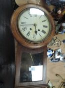 An oak case all clock with glass door and Roman numerals to enamel face.