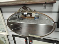 A late Victorian mantle mirror having copper work frame
