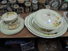A selection of art deco dinner service having bright floral design to cream ground,included are