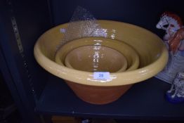 A set of graduated earthen ware farm house cream or butter bowls in good condition