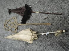 Two Victorian parasols, one with intricately carved handle and fringing,AF and a carpet beater.