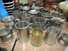 A large collection of tankards, some monogrammed, others having hammered effect, some etched.