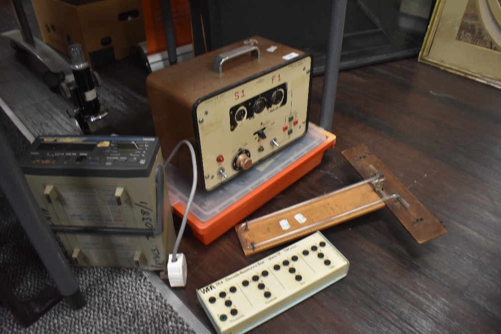 A selection of scientific test equipment including Panax, a microscope and multimeter