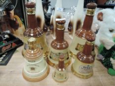 A variety of Wade ceramic Bell whiskey bottles.
