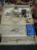 A box of vintage costume jewellery including Faceted glass necklace,brooches and more.