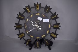 A mid century styled metal wall clock by Smiths decorated with signs of the Zodiac