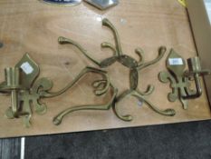 Two brass wall mounted candle stick holders and six coat hooks.