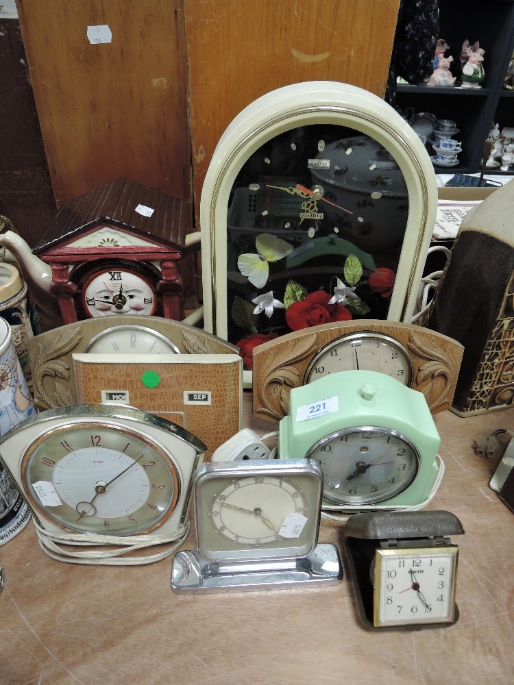 An assortment of vintage clocks and alarm clocks.