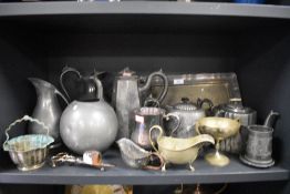 A selection of pewter and metal wares including teapots and tray