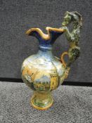 An antique Italian majollica ewer or urn decorated with scene of bull being cooked with horse handle
