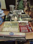 An assortment of flat ware including boxed fish set, meat servers, knives and forks and more.
