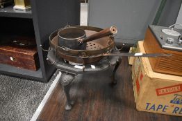 A travellers or gypsy style cooking tripod stand with pans and hanging rack