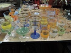A selection of mid century colourful drinking glasses.