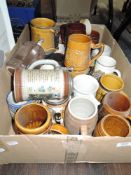 A box full of vintage ceramic tankards,mugs and steins.