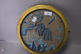 An antique circular framed wool work embroidery