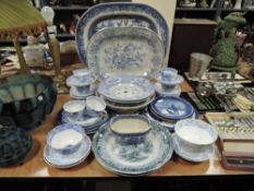 A mixed lot of antique blue and white ware including platters, plates,cups and saucers and more.