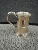 A large plated tankard having monogram to front.