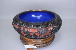 A Cinnabar lacquer Japanese bowl decorated with mythical landscape on blue enamel base with carved