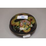 A Japanese cloisonne lidded dish or bowl decorated with mythical dragon on black ground