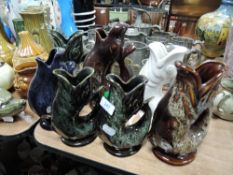 A selection of studio pottery fish jugs or vases.