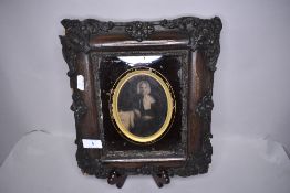 A Victorian portrait in a very ornate frame