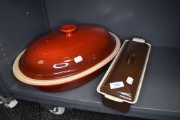 A Le Creuset casserole dish with lid and similar meatloaf pot, both as new