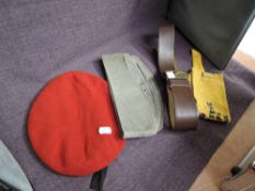 Two German Side Caps, a German Red Beret, a Russian Leather Belt with brass buckle and a Yellow