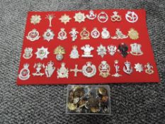 A collection 37 modern Cap Badges on board and a box of Military Buttons and Badges