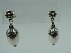 A pair of silver stud earrings by Georg Jensen modelled as acorns from a flower drop, model no 4,