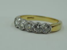 A half eternity ring, having five diamonds, total approx 1.5ct in collared mounts on an 18ct gold