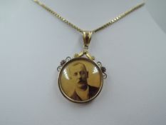 A glass locket of circular form having 9ct gold mount on a later 9ct gold box chain, clasp broken,