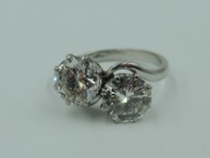 A diamond dress ring having a duo of diamonds, each approx 1.5ct in a claw set crossover mount on