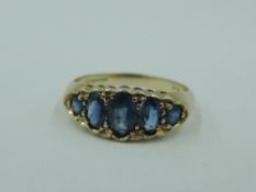 A five stone graduated powder blue sapphire dress ring in a pave set gallery mount on a 9ct gold
