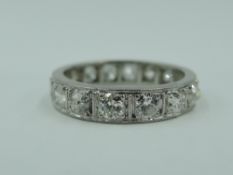 A diamond set full eternity ring having 16 old cut diamonds, total approx 1ct in a white metal loop,