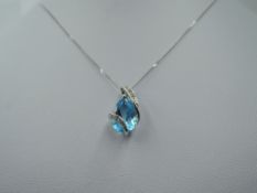 A blue topaz pendant of teardrop form having diamond chip set 9ct white gold mount on 9ct white gold