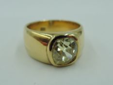 A yellow metal signet ring stamped 18 having an inset champagne coloured old cut diamond, approx
