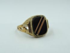 A gent's 9ct gold signet ring having striped panel and moulded shoulders, size Z & approx 4.6g