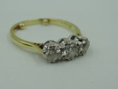 A diamond trilogy ring, total approx 1ct in a claw set mount on an 18ct gold loop, size S & approx